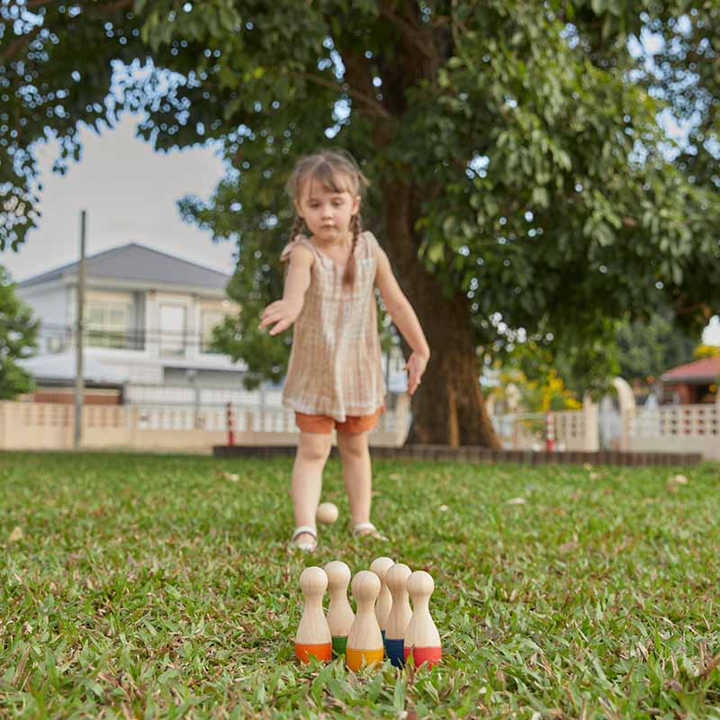Wooden Toy Bowling Set Girl on grass